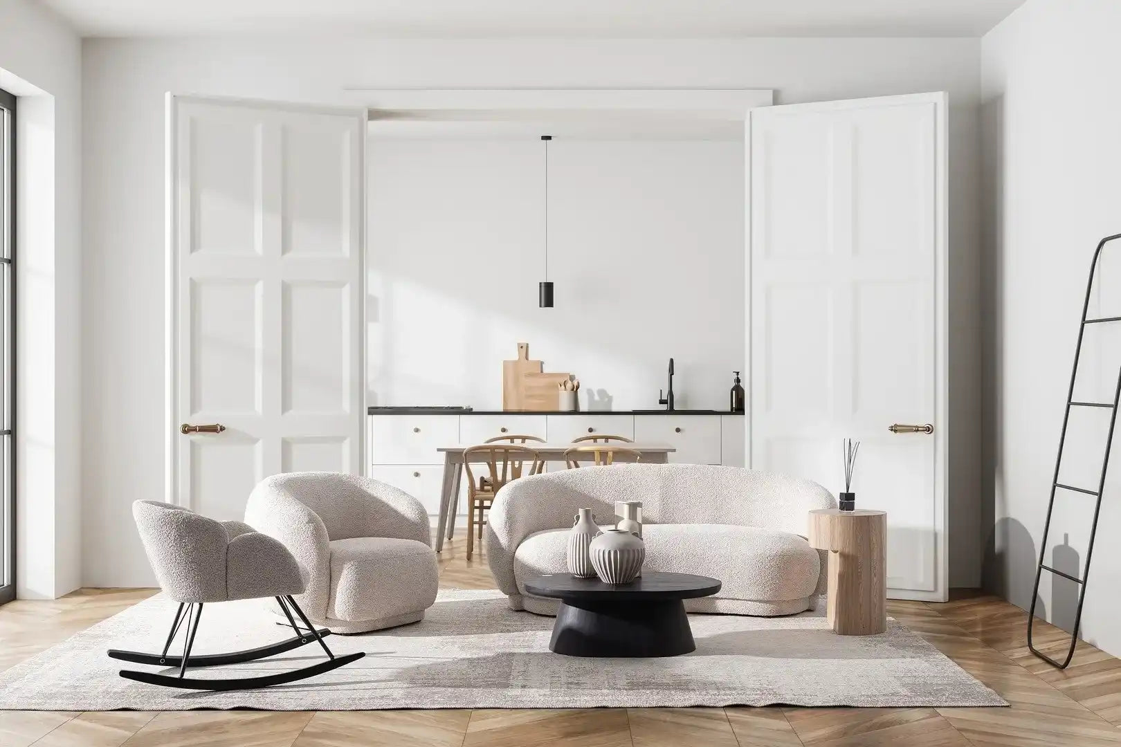 A contemporary living room with a cream-colored curved sofa, two matching armchairs, and a black coffee table.